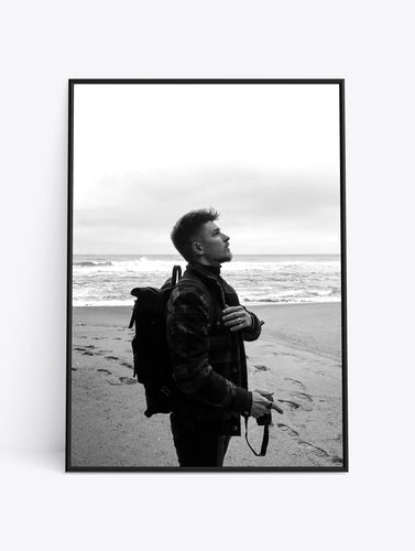 Man on beach looking up.