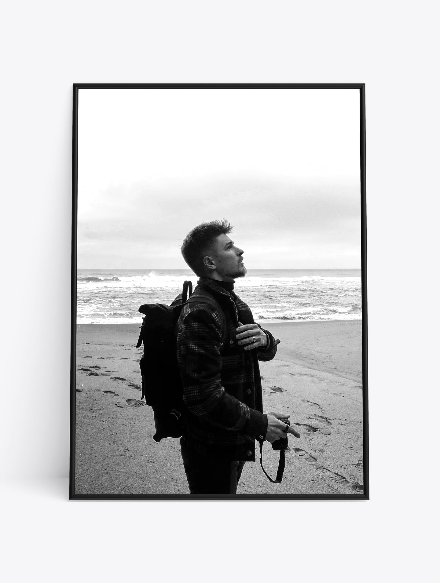 Man on beach looking up.